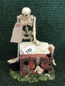 A novelty cast metal money bank - Skeleton