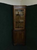 A yew wood corner cabinet