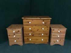 A pine four drawer chest and pair of three drawer chests