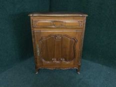 A French walnut cabinet fitted a drawer
