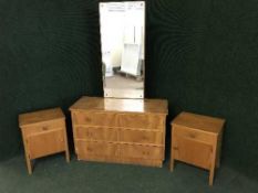 A three drawer dressing chest and pair of bedside cabinets