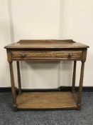 An Ercol elm side table fitted with a drawer