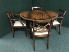 A mahogany Regency style pedestal table and four chairs
