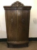 An early 20th century carved oak cabinet