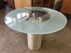 A circular coffee table on stone base