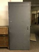A heavy duty metal fire door in frame