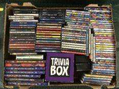 A box of Now Cds and DVDs and other compilation Cds