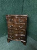 A mahogany serpentine fronted four drawer chest