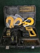 A cased Dewalt drill and a box of overalls,