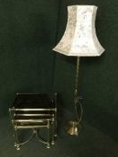 A nest of three brass and glass topped tables and a brass standard lamp