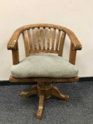 A pine horseshoe swivel chair