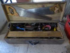 A joiner's tool box containing hand tools, saws, braces,