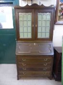 An early twentieth century oak bureau bookcase with leaded glass doors