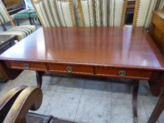 A mahogany drop end sofa coffee table fitted with three drawers