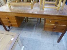 A mid twentieth century teak twin pedestal desk