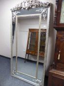 An ornate silvered sectional mirror