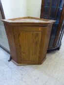An oak hanging corner cupboard
