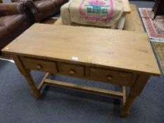 A reclaimed pine three drawer side table