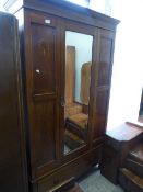 A late Victorian inlaid mahogany mirror door wardrobe