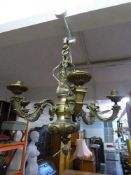 A decorative metal five branch chandelier with marble shades together with three marble table lamps