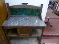 An Edwardian oak marble topped wash stand