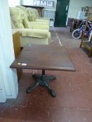 A mahogany occasional table on cast metal support