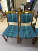 A set of four continental oak dining chairs upholstered in turquoise striped fabric