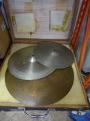 A wooden box containing three cymbals