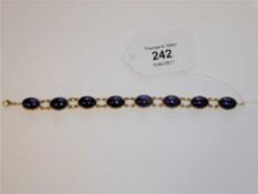 An 18ct gold bracelet set with lapis lazuli cabochon stones,