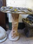 A garden squirrel bird bath