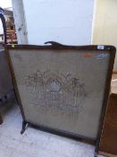 A large oak tapestry fire screen with silver thread depicting the Taj Mahal