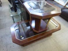 A contemporary shaped glass topped coffee table and matching lamp table