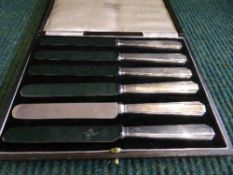 A set of six cased Northern Goldsmiths silver handled butter knives