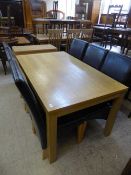 A rectangular dining table and six brown leather high backed chairs