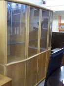 A contemporary Skovby light oak four door display cabinet