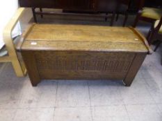 A carved oak blanket box