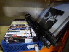 A box of assorted dvds, camera tripod,