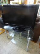 An LG 32 inch LCD TV on stand