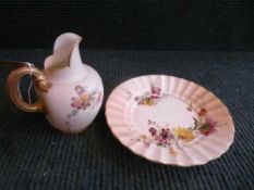 A Royal Worcester hand painted blush ivory gilt handled jug,