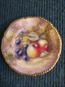 A Royal Worcester hand painted plate depicting fruit, with gilded border, signed J Smith,
