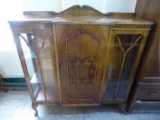 A walnut break-front display cabinet