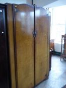 A walnut double door wardrobe and knee hole dressing table