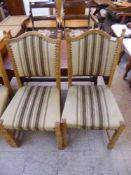 A set of six oak dining chairs upholstered in beige striped fabric