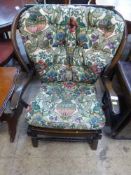 A mid 20th century Ercol wing back armchair