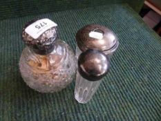 A silver lidded scent bottle and two silver lidded jars