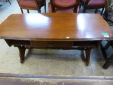 A contemporary refectory coffee table fitted a drawer