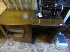A Federation treadle sewing machine in walnut cabinet