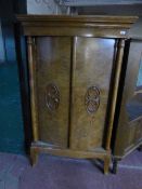 A continental walnut double door cabinet