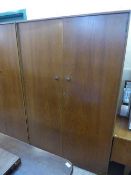 A three piece teak bedroom suite