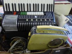 A box of Hohner electravox accordion together with a Bush radio